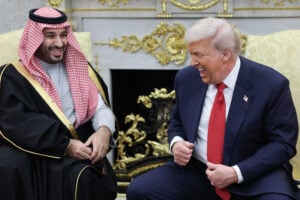 U.S. President Donald Trump (R) jokes with Crown Prince and Prime Minister Mohammed bin Salman of Saudi Arabia during a bilateral meeting in the Oval Office of the White House on November 18, 2025 in Washington, DC.