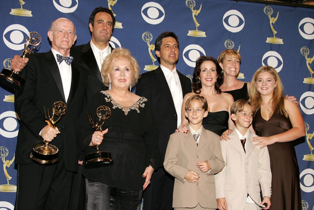 The cast of 'Everybody Loves Raymond', (L-R) Peter Boyle, Brad Garrett, Doris Roberts, Ray Romano, Patricia Heaton, Monica Horan, Sawyer Sweeten, Sullivan Sweeten and Madylin Sweeten pose with the Emmy for Outstanding Comedy Series in the press room at the 57th Annual Emmy Awards held at the Shrine Auditorium on September 18, 2005 in Los Angeles, California.
