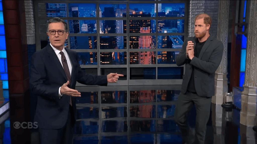 Stephen Colbert gestures to Prince Harry