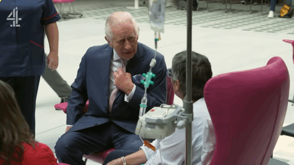 King Charles sits and chats with a cancer patient.