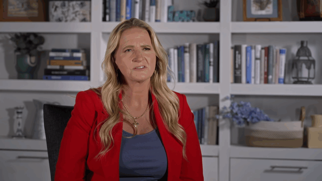 Christine Brown in a bold red blazer.