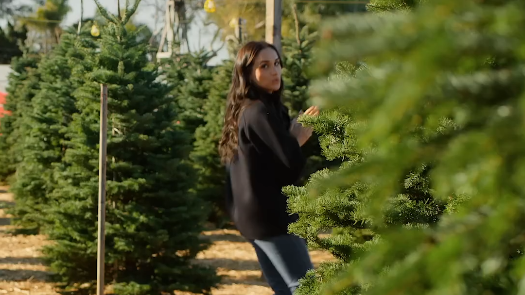 Meghan Markle looks mischievous among the trees.