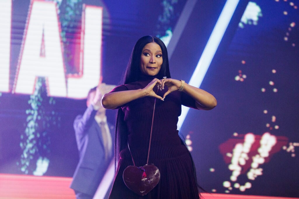 Nicki Minaj enters the stage as the surprise guest on the final day of Turning Point USA's annual AmericaFest conference at the Phoenix Convention Center on December 21, 2025 in Phoenix, Arizona.  