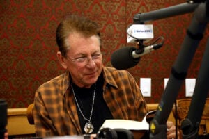 Joe Ely reads from his new book "Reverb" while visiting Mojo Nixon in Celebration of his 10 Year Anniversary On SiriusXM with A special live show at the SiriusXM Studios on November 12, 2014 in Austin, Texas.