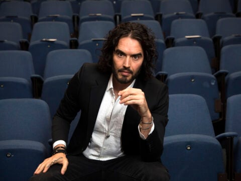 Russell Brand poses for photographs as he arrives to deliver The Reading Agency Lecture at The Institute of Education on November 25, 2014 in London, England.