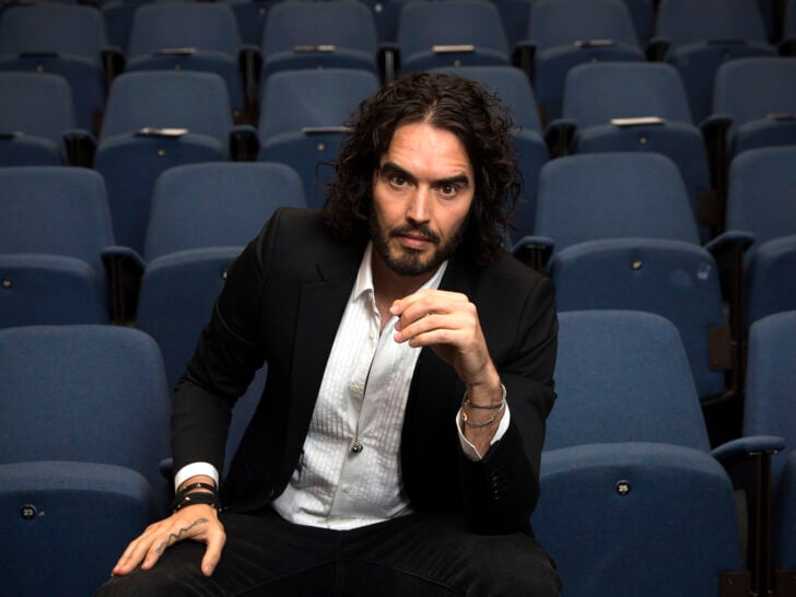 Russell Brand poses for photographs as he arrives to deliver The Reading Agency Lecture at The Institute of Education on November 25, 2014 in London, England.