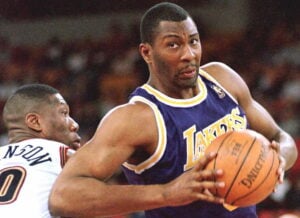 Los Angeles Lakers Elden Campbell shoots around Denver Nuggets Ervin Johnson during first half action of their game 17 March at McNichols Sports Arena in Denver, Co.