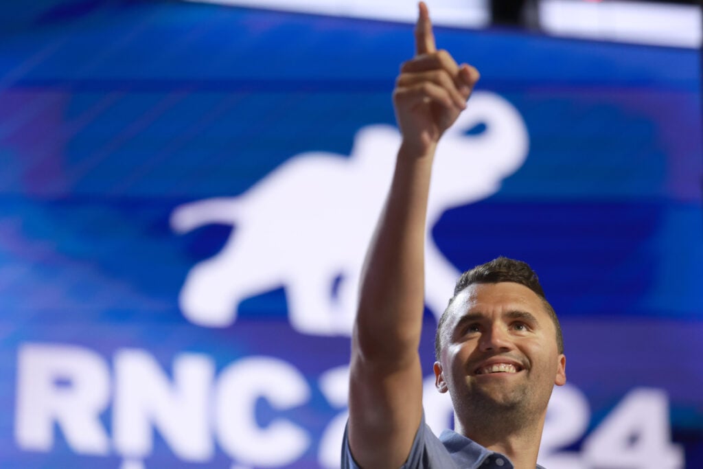 Charlie Kirk raises his hand in July 2024.