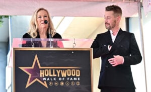 US actor Macaulay Culkin looks on as Canadian-US actress Catherine O'Hara speaks during his Hollywood Walk of Fame Star ceremony in Hollywood, California, on December 1, 2023.