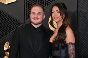US country musician Zach Bryan and girlfriend Brianna Chickenfry arrives for the 66th Annual Grammy Awards at the Crypto.com Arena in Los Angeles on February 4, 2024.