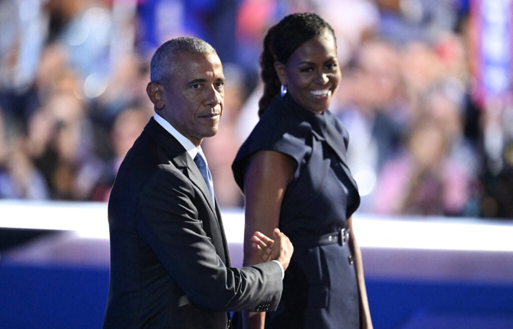 Former US President Barack Obama and his wife and former First Lady Michelle Obama stand on stage after she introduced him on the second day of the Democratic National Convention (DNC) at the United Center in Chicago, Illinois, on August 20, 2024.