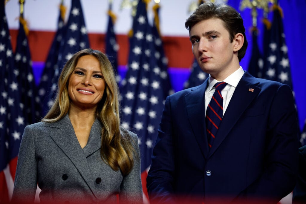 Former first lady Melania Trump and Barron Trump look on as Republican presidential nominee, former U.S. President Donald Trump speaks during an election night event at the Palm Beach Convention Center on November 06, 2024 in West Palm Beach, Florida. 