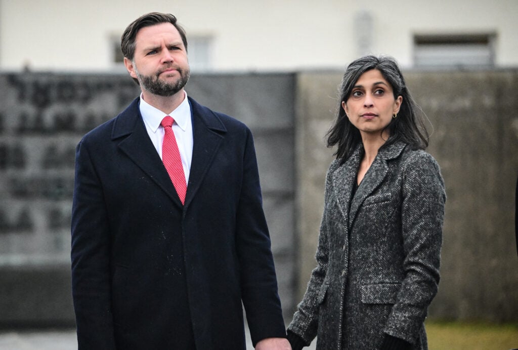 US Vice President JD Vance stands with his wife Usha Vance as they take part in a tour of the Dachau Concentration Camp memorial site in Dachau, southern Germany, on February 13, 2025.