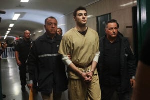 Luigi Mangione is escorted by police as he arrives for a hearing as his lawyers push to have his state murder charges dismissed in the killing of UnitedHealthcare CEO Brian Thompson, at Manhattan Criminal Court on September 16, 2025 in New York City.