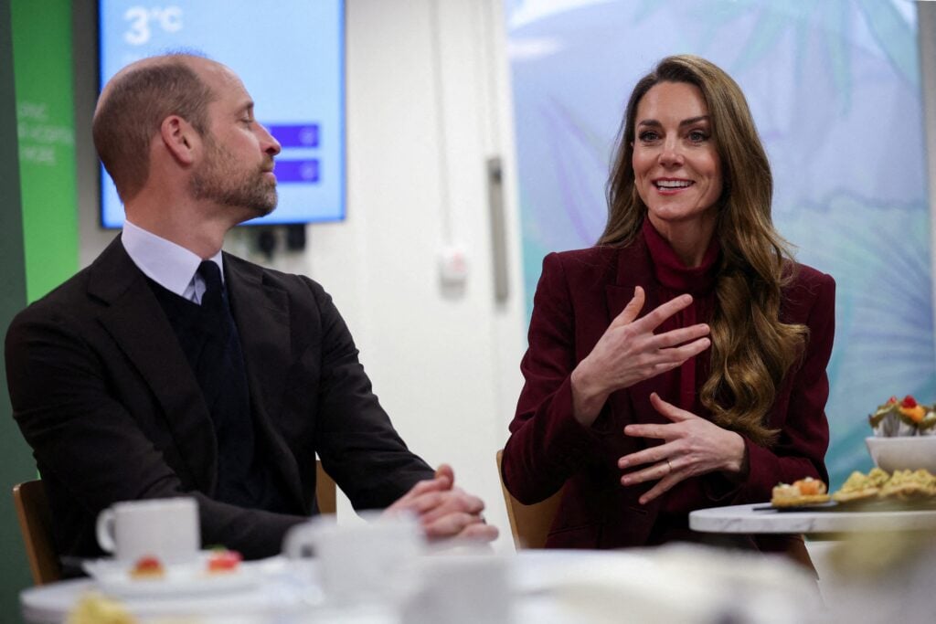 Britain's Prince William (L), Prince of Wales, looks on as Catherine (R), Princess of Wales, speaks with healthcare staff during a visit to Charing Cross Hospital in west London on January 8, 2026, to highlight the work of NHS staff and volunteers.