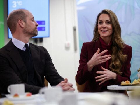 Britain's Prince William (L), Prince of Wales, looks on as Catherine (R), Princess of Wales, speaks with healthcare staff during a visit to Charing Cross Hospital in west London on January 8, 2026, to highlight the work of NHS staff and volunteers.