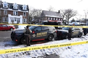 Members of the Hennepin County Sheriff's Office look on as people gather near the scene of a suspected shooting by an ICE agent during federal law enforcement operations on January 07, 2026 in Minneapolis, Minnesota.