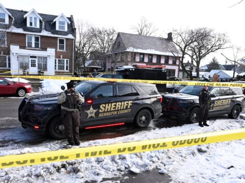 Members of the Hennepin County Sheriff's Office look on as people gather near the scene of a suspected shooting by an ICE agent during federal law enforcement operations on January 07, 2026 in Minneapolis, Minnesota.