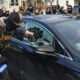 A federal officer breaks a car window as they begin the process of removing a woman from her vehicle near an area where ICE was operating in Minneapolis, Minnesota, on January 13, 2026.