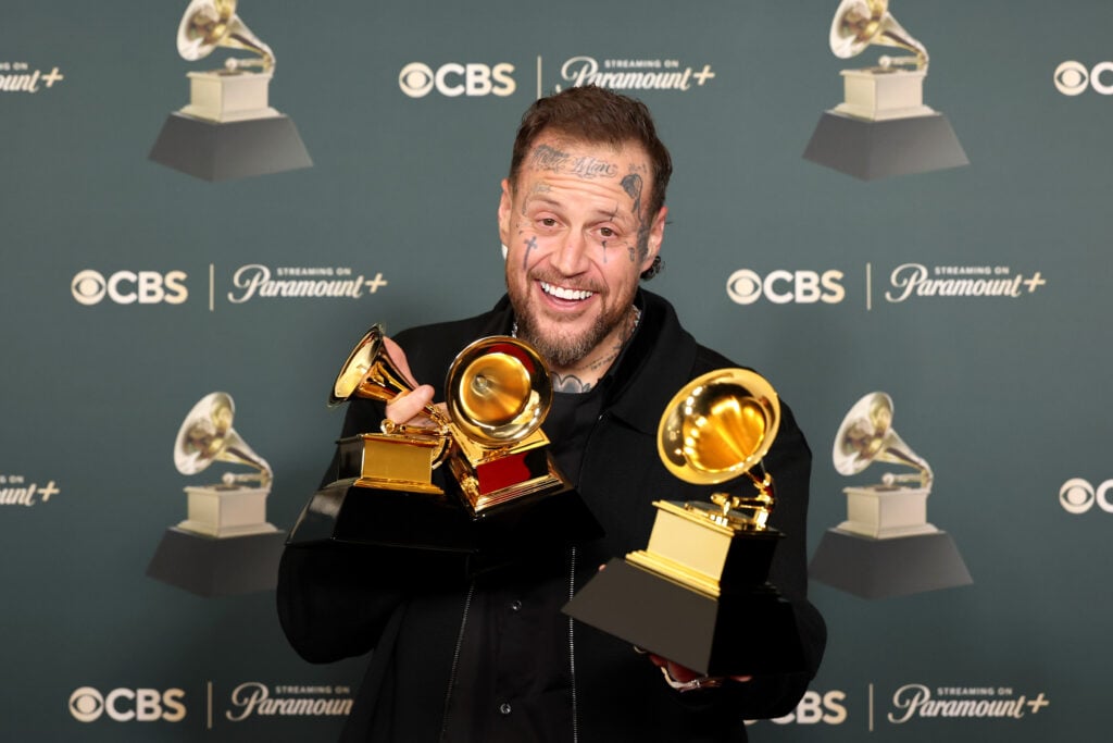 Jelly Roll with Grammy Awards in his arms.