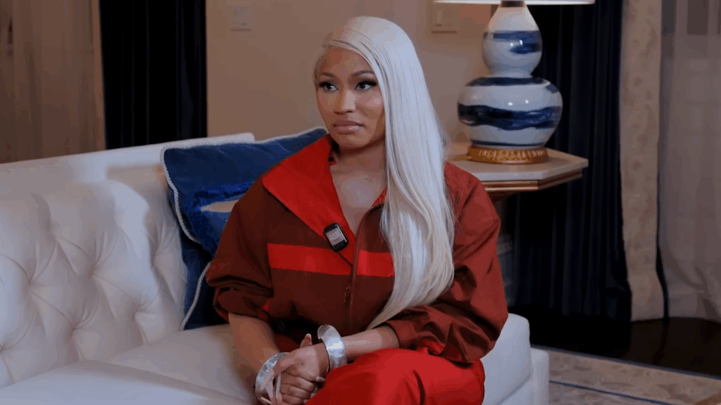 Nicki Minaj sits and stares.