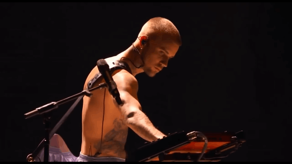 Justin Bieber shirtless on stage.