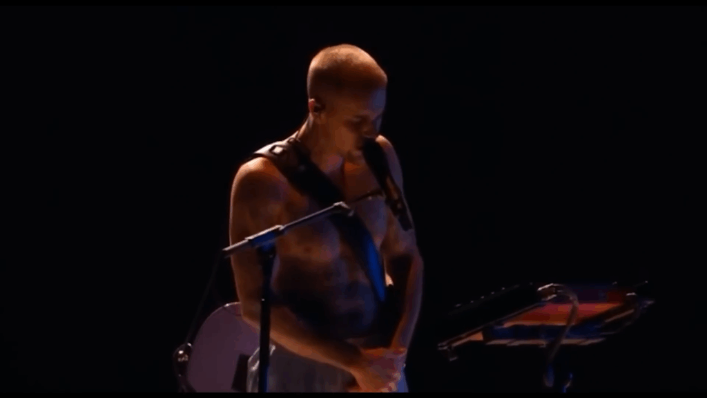 Justin Bieber bares his torso wearing only underwear on the Grammys stage.