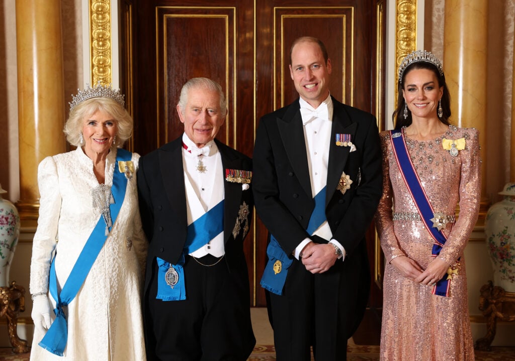 Queen Camilla, King Charles III, Prince William, Prince of Wales and Catherine, Princess of Wales pose for a photograph ahead of The Diplomatic Reception in the 1844 Room at Buckingham Palace on December 05, 2023 in London, England. 
