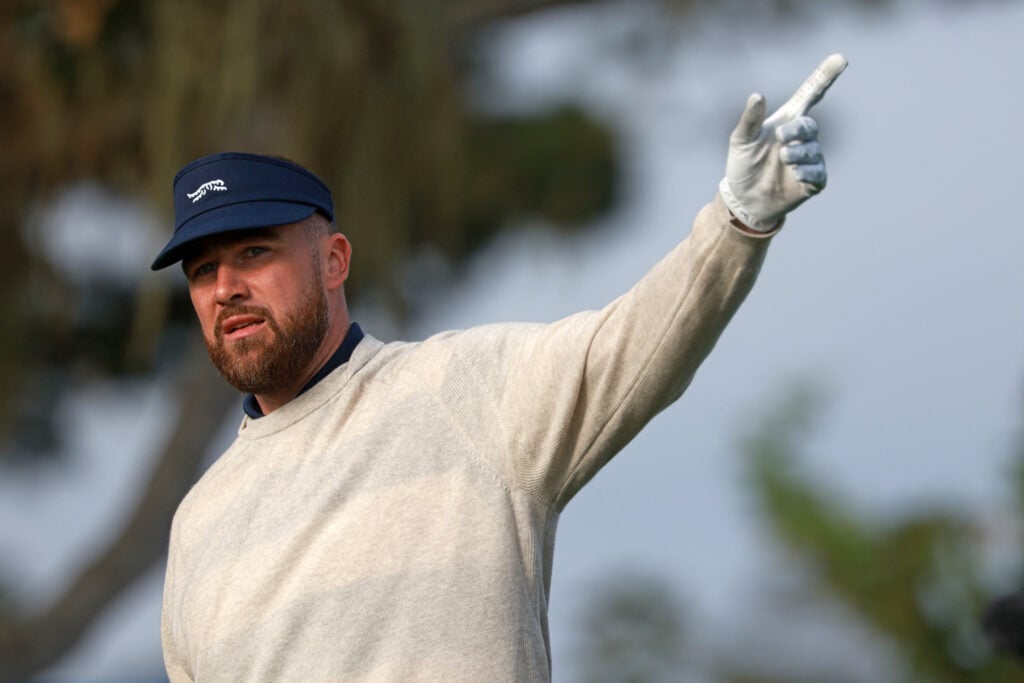 NFL player Travis Kelce reacts to his shot from the second tee during the second round of the AT&T Pebble Beach Pro-Am 2026 at Pebble Beach Golf Links on February 13, 2026 in Pebble Beach, California.