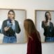 A woman looks at photos of late singer Kurt Cobain, posing with a handgun, as part of the exhibition "The Last Shooting" on March 28, 2014 at the Addict gallery in Paris.