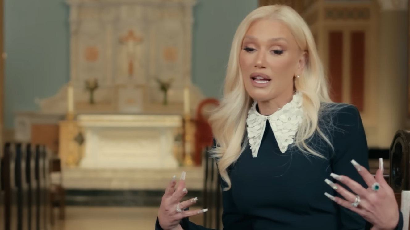 Gwen Stefani speaks and gestures in a church.