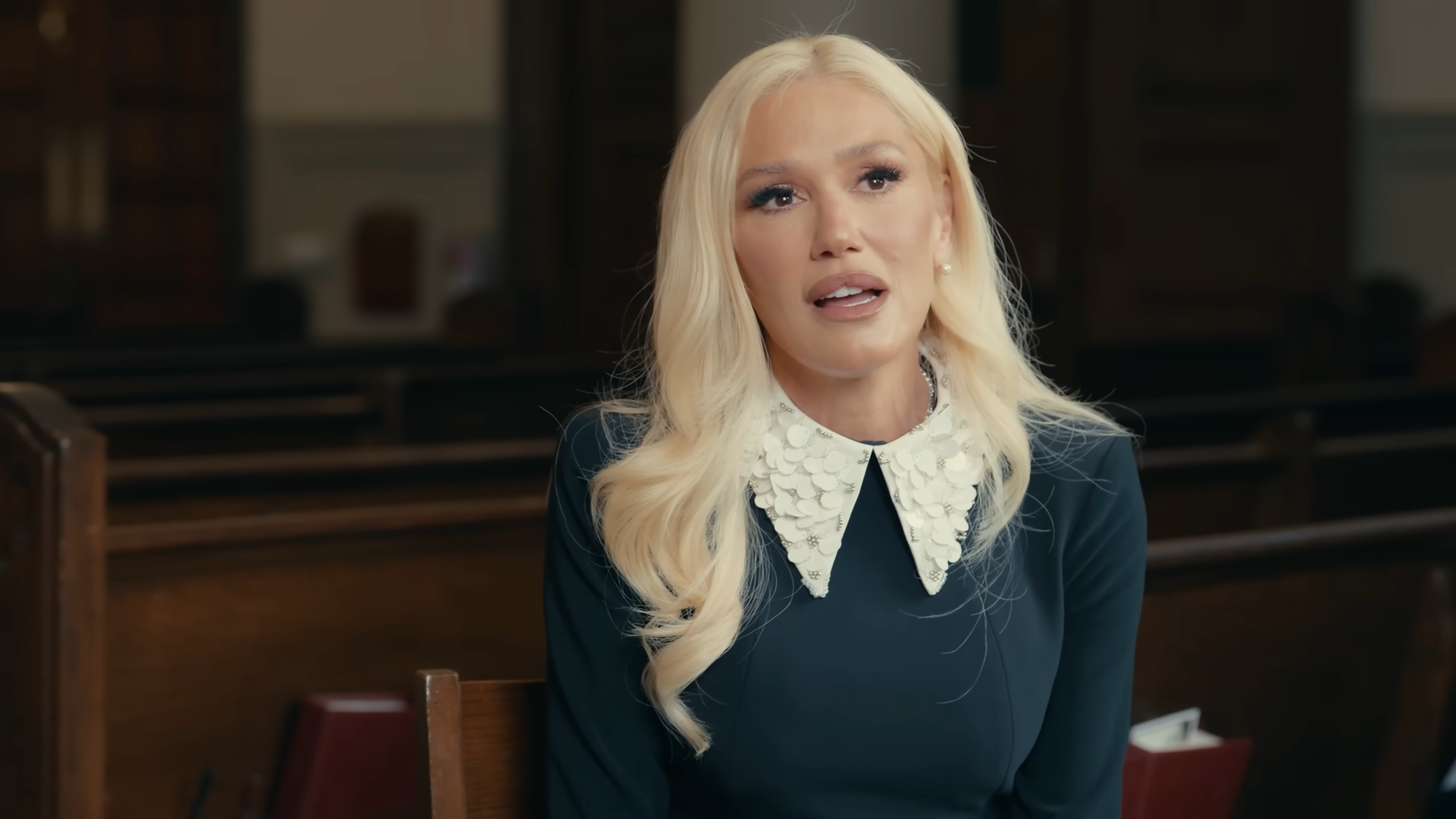 Gwen Stefani contemplates in a church