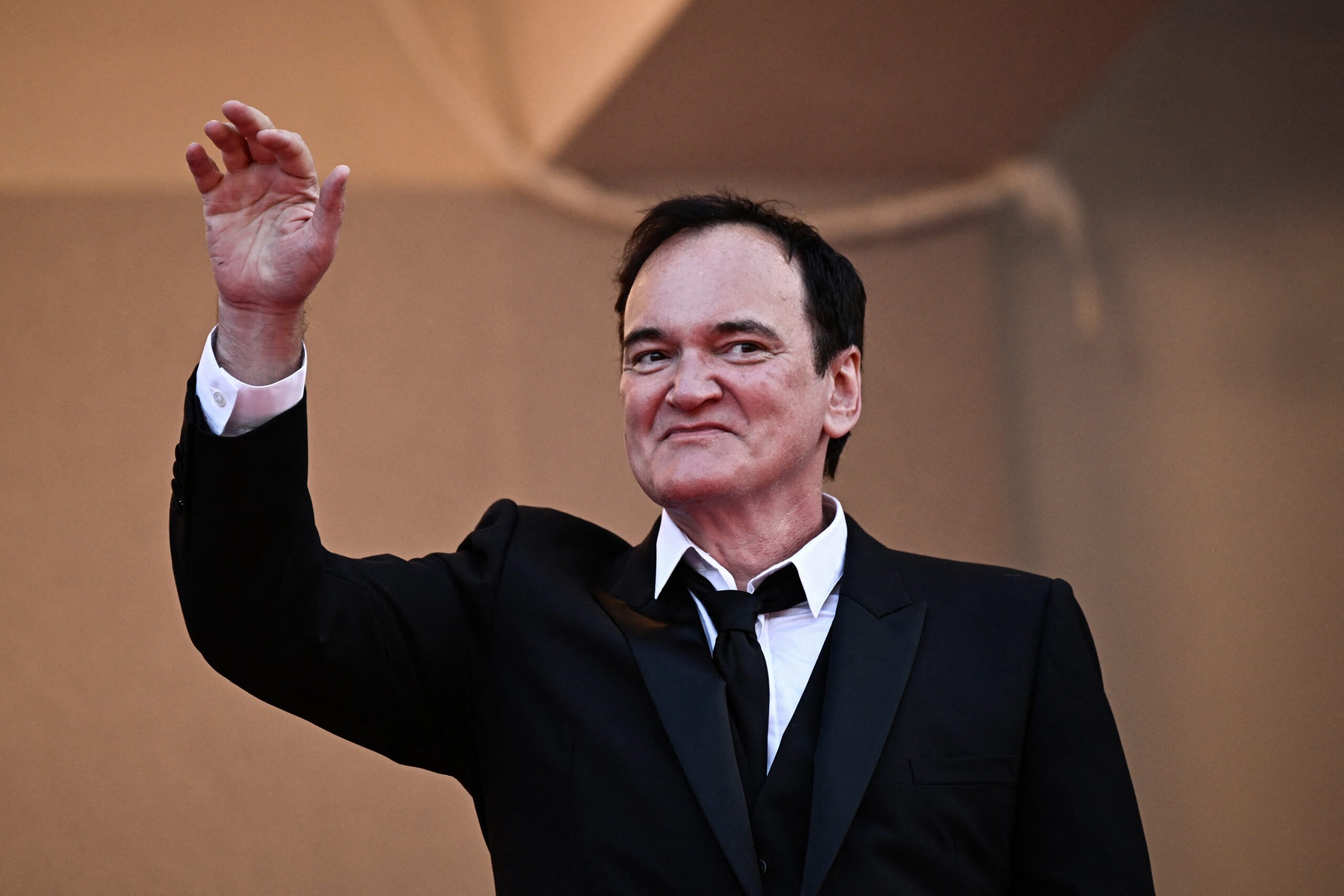 American director Quentin Tarantino waves as he arrives for the closing ceremony and screening of the film 