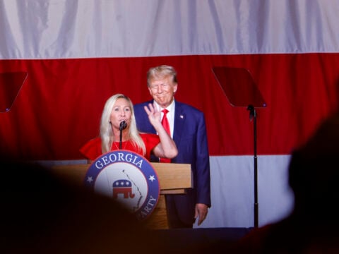 Former U.S. President Donald Trump looks on as Rep. Marjorie Taylor Greene (R-GA) speaks during his remarks at the Georgia state GOP convention at the Columbus Convention and Trade Center on June 10, 2023 in Columbus, Georgia.