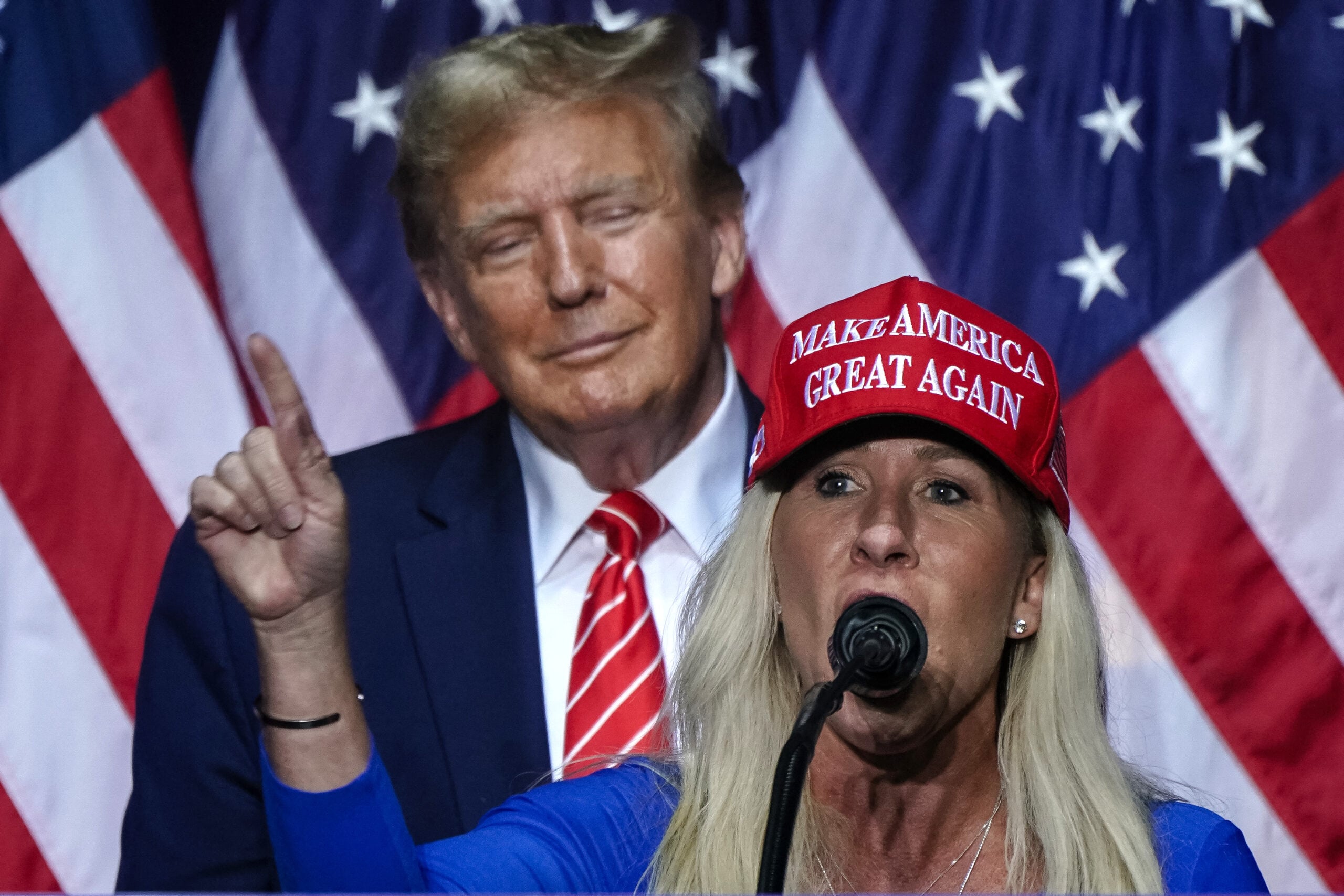 Actress Marjorie Taylor Greene (right) speaks alongside former US President and 2024 presidential candidate Donald Trump at a campaign event in Rome, Georgia, on March 9, 2024.