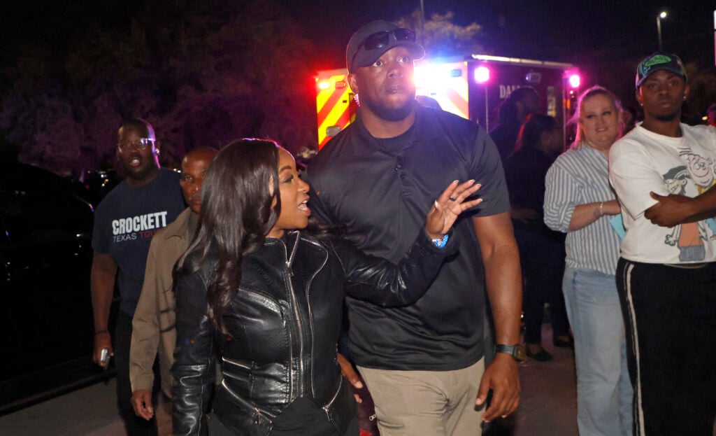 Rep. Jasmine Crockett (D-TX) with security guard known as Mike King and later identified as 39-year-old Diamon-Mazairre Robinson, arrives to greet supporters on February 27, 2026 in Dallas, Texas.  