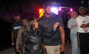 Rep. Jasmine Crockett (D-TX) with security guard known as Mike King and later identified as 39-year-old Diamon-Mazairre Robinson, arrives to greet supporters on February 27, 2026 in Dallas, Texas.