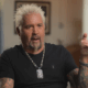Guy Fieri speaks in an interview.