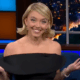 Sydney Sweeney smiles and shrugs on Colbert.