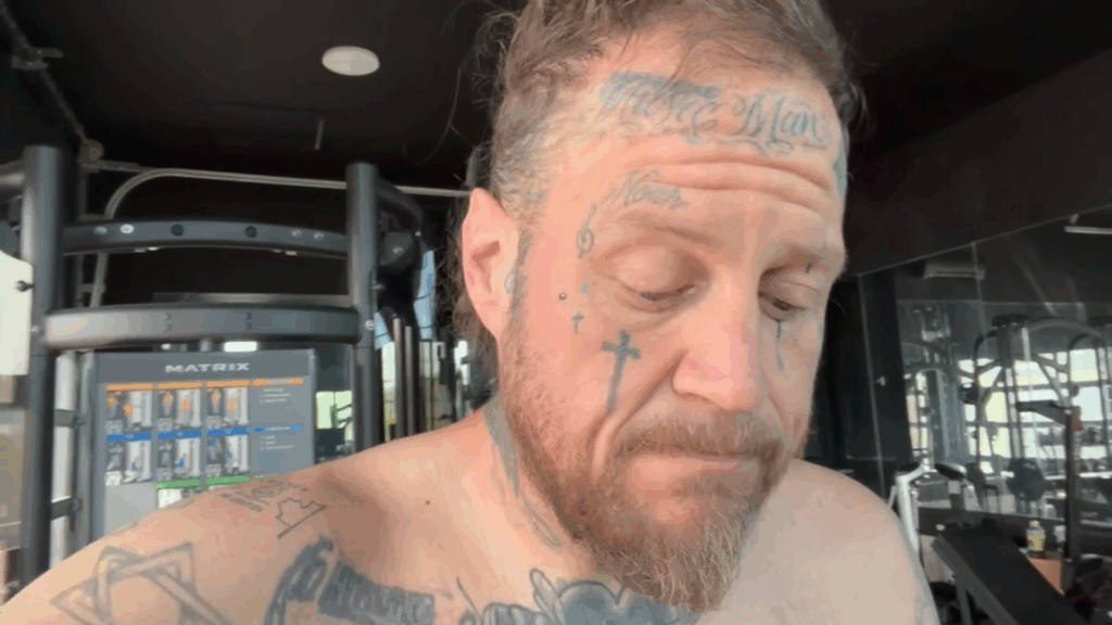 Jelly Roll looks anxious while shirtless.