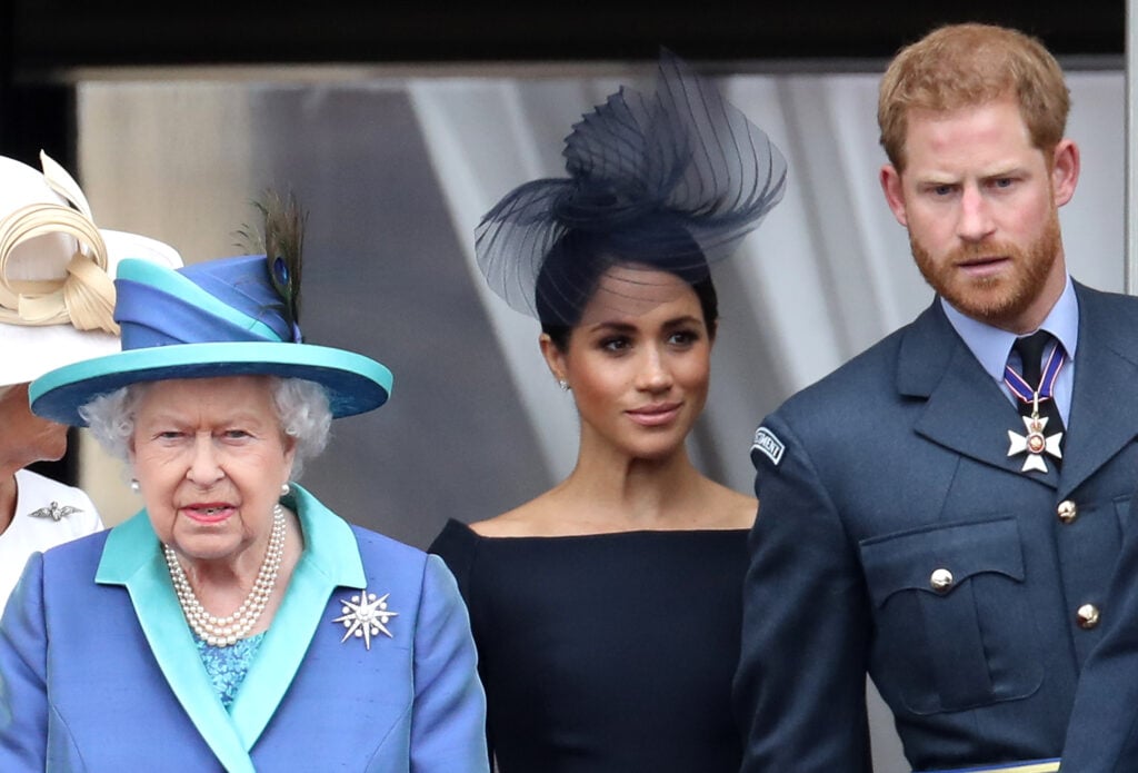 Queen Elizabeth II, Prince Harry, Duke of Sussex and Meghan, Duchess of Sussex on the balcony of Buckingham Palace as the Royal family attend events to mark the Centenary of the RAF on July 10, 2018 in London, England. 