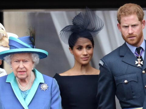 Queen Elizabeth II, Prince Harry, Duke of Sussex and Meghan, Duchess of Sussex on the balcony of Buckingham Palace as the Royal family attend events to mark the Centenary of the RAF on July 10, 2018 in London, England.