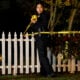 An LAPD officer puts up tape as the police investigate two people found dead in Rob Reiner's home on December 14, 2025 in Brentwood, California.