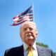 U.S. President Donald Trump speaks in front of the American flag to the press as he departs the White House on May 12, 2026 in Washington, DC.
