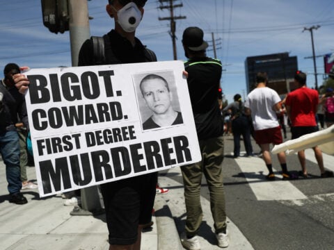 A protester holds a sign with a photo of former Minneapolis police officer Derek Chauvin during demonstrations following the death of George Floyd on May 30, 2020 in Los Angeles, California.