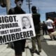 A protester holds a sign with a photo of former Minneapolis police officer Derek Chauvin during demonstrations following the death of George Floyd on May 30, 2020 in Los Angeles, California.