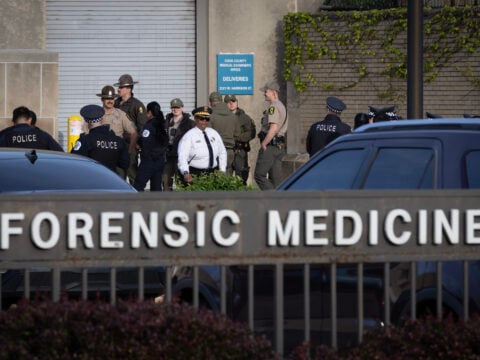 Police officers gather outside of the county morgue as the remains of a fellow officer who was fatally shot in the line of duty arrive from the hospital on April 25, 2026 in Chicago, Illinois.