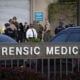 Police officers gather outside of the county morgue as the remains of a fellow officer who was fatally shot in the line of duty arrive from the hospital on April 25, 2026 in Chicago, Illinois.