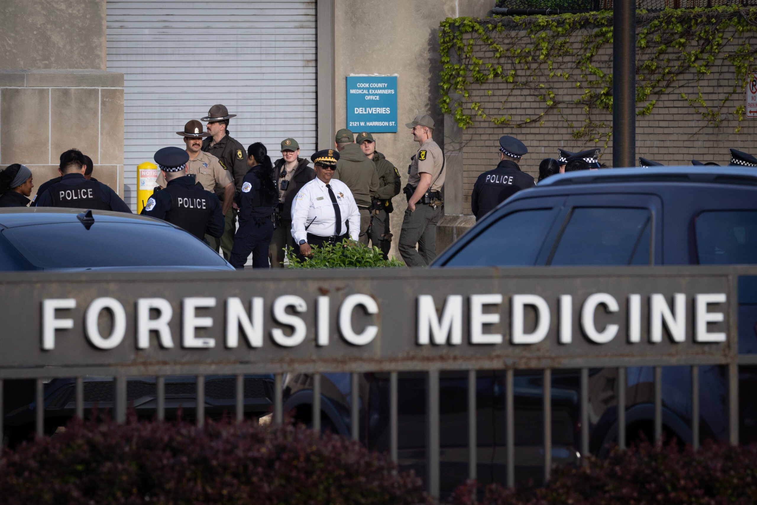 Police officers gather outside of the county morgue as the remains of a fellow officer who was fatally shot in the line of duty arrive from the hospital on April 25, 2026 in Chicago, Illinois. 