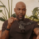 Karamo Brown speaks on a podcast.